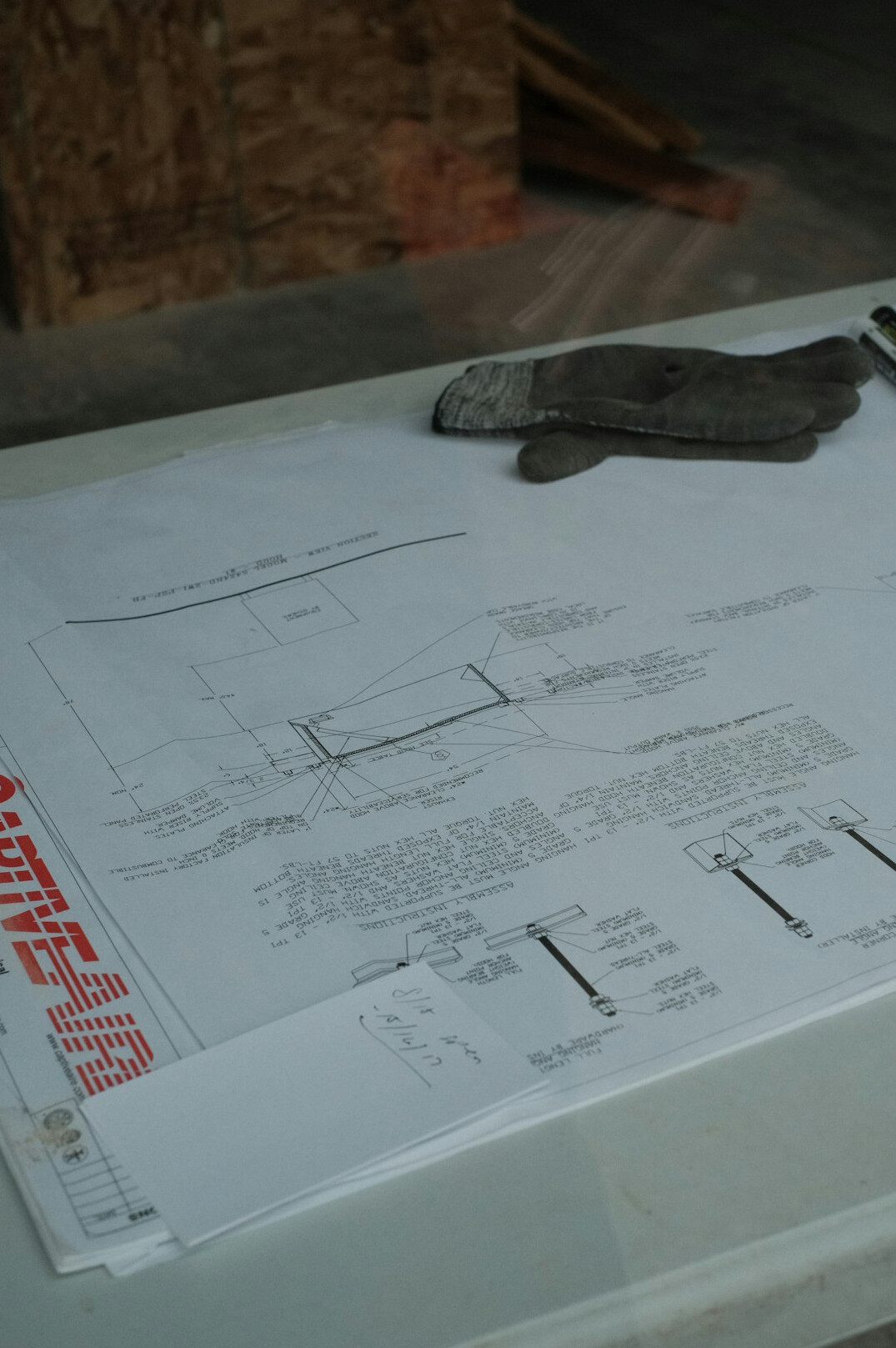 Architects reviewing blueprints on a wooden table in a bright office