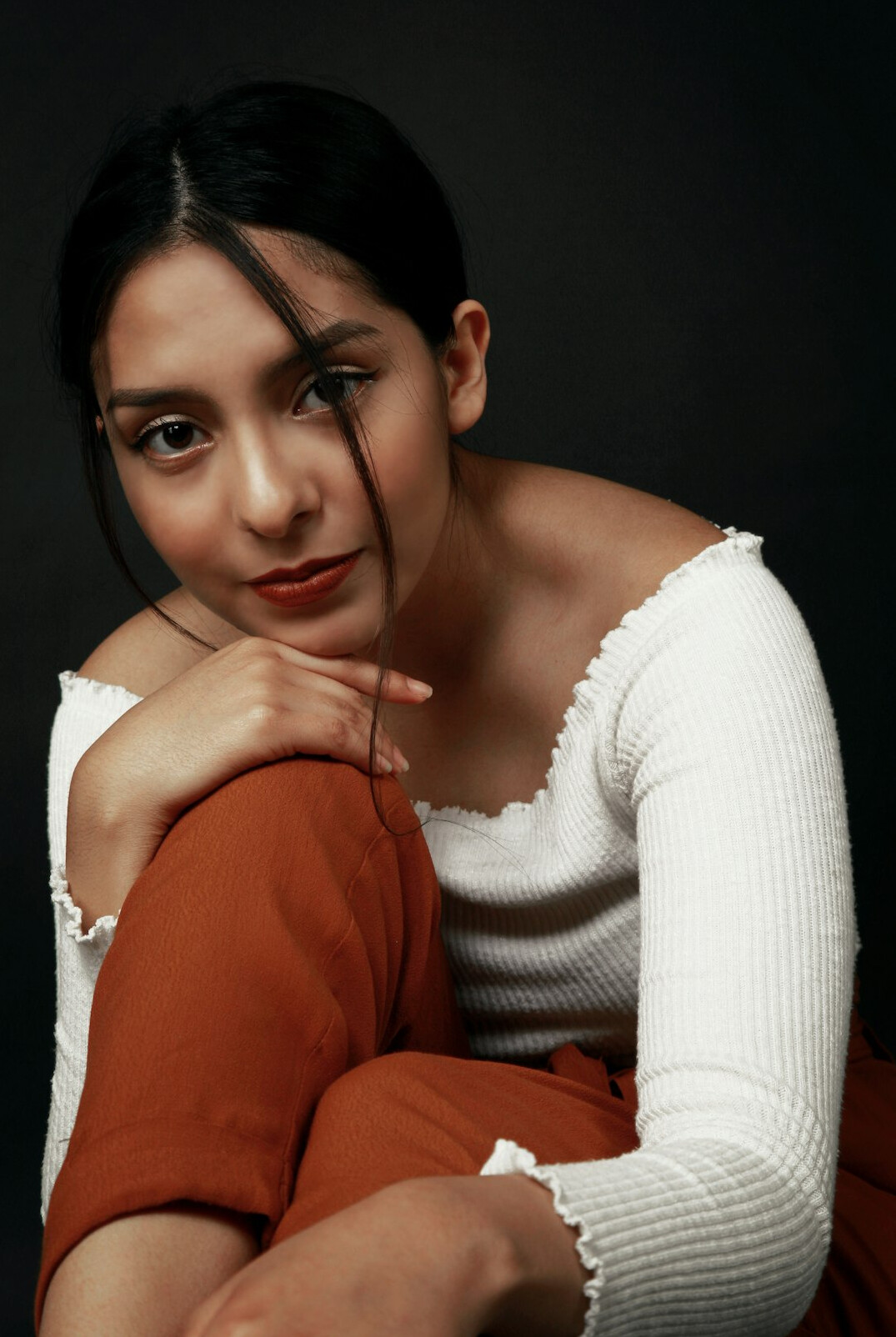Studio portrait of a South American woman in her thirties with a warm smile